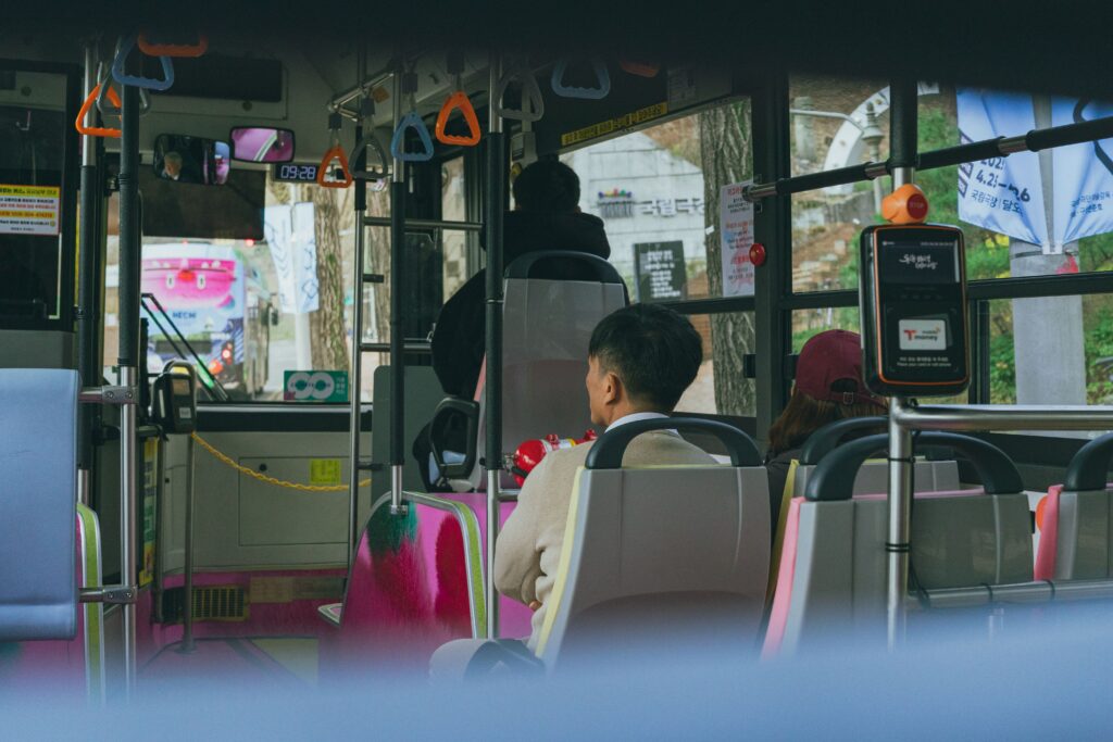 Passengers ride a bus in Seoul